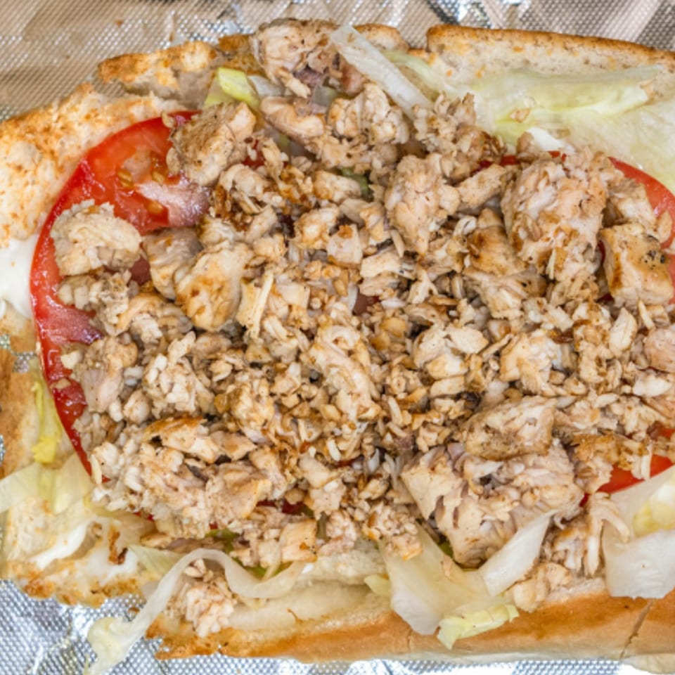 Liberty Pizza & Sub's chicken sub with chopped chicken, lettuce, tomatoes, and onions.